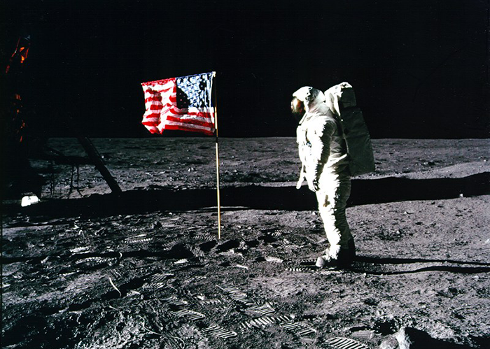 Astronaut planting American Flag
